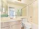 Bathroom with vanity, toilet, mirror, and a shower and tub combo at 3971 E Heather Ct, Gilbert, AZ 85234