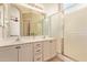 Bright bathroom with double vanity, white cabinets, and glass-enclosed shower at 3971 E Heather Ct, Gilbert, AZ 85234