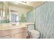 Well-lit bathroom featuring vanity, toilet, mirror, and shower with decorative curtain at 3971 E Heather Ct, Gilbert, AZ 85234
