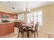 Cozy dining area with warm lighting, seating for four, and large sunlit window at 3971 E Heather Ct, Gilbert, AZ 85234
