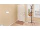 Bright entryway with light tile flooring, white door, and coat rack for extra storage at 3971 E Heather Ct, Gilbert, AZ 85234