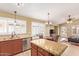 Open kitchen with granite countertops, stainless steel appliances, and tile flooring at 3971 E Heather Ct, Gilbert, AZ 85234
