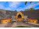 Charming outdoor fireplace with seating area, perfect for cozy evenings and outdoor gatherings at 3971 E Heather Ct, Gilbert, AZ 85234