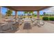 Community picnic area with multiple wooden picnic tables under a covered structure, providing shade and seating at 3971 E Heather Ct, Gilbert, AZ 85234