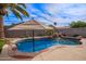 Beautiful backyard pool with rock waterfall and lush landscaping, creating a serene oasis for relaxation and recreation at 3971 E Heather Ct, Gilbert, AZ 85234