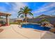Beautiful backyard pool with rock waterfall and lush landscaping, creating a serene oasis for relaxation and recreation at 3971 E Heather Ct, Gilbert, AZ 85234