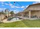 Backyard oasis features a pool, lush landscaping and covered patio at 4019 W Charlotte Dr, Glendale, AZ 85310