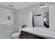 Bright bathroom with a glass enclosed shower and single sink vanity at 4019 W Charlotte Dr, Glendale, AZ 85310