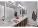 Bright bathroom features double sinks, a large mirror and updated lighting at 4019 W Charlotte Dr, Glendale, AZ 85310