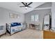 Well-lit bedroom boasts a ceiling fan, plantation shutters, and neutral carpet at 4019 W Charlotte Dr, Glendale, AZ 85310