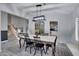Well-lit dining room with a dining table, seating for six, a hutch, and views of the living room at 4019 W Charlotte Dr, Glendale, AZ 85310