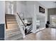 Welcoming entryway featuring tile flooring, stairs leading upstairs, and a view into the living room at 4019 W Charlotte Dr, Glendale, AZ 85310