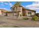 Attractive two-story home featuring manicured desert landscaping, a three-car garage, and stylish facade at 4019 W Charlotte Dr, Glendale, AZ 85310