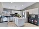 Charming kitchen with a kitchen island, modern appliances, and white cabinetry at 4019 W Charlotte Dr, Glendale, AZ 85310