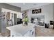 Kitchen with white center island, stainless fridge, and an open concept at 4019 W Charlotte Dr, Glendale, AZ 85310