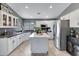 Charming kitchen with a kitchen island, modern appliances, and white cabinetry at 4019 W Charlotte Dr, Glendale, AZ 85310