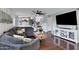 Open concept living room with hardwood floors and large dark gray couch at 4019 W Charlotte Dr, Glendale, AZ 85310