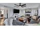 Comfortable living room with a stone fireplace, ceiling fan, hardwood floors, and neutral paint at 4019 W Charlotte Dr, Glendale, AZ 85310