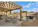 Covered patio with an outdoor dining area and barbecue creates a relaxing and functional space for outdoor entertaining at 4019 W Charlotte Dr, Glendale, AZ 85310