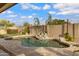 Gorgeous swimming pool featuring rock features and swaying palms with blue skies for a serene backyard oasis at 4019 W Charlotte Dr, Glendale, AZ 85310