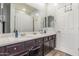 Bathroom featuring a dual sink vanity with dark cabinets and a large mirror at 4136 W Palace Station Rd, New River, AZ 85087