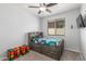 Cozy bedroom with bed, carpet floors, colorful storage cubes, and bright natural light from the window at 4136 W Palace Station Rd, New River, AZ 85087