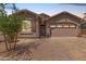 Charming single-Gathering home featuring a two-car garage, desert landscaping, and a welcoming front entrance at 4136 W Palace Station Rd, New River, AZ 85087
