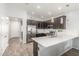 Well-lit kitchen with stainless steel appliances, dark cabinetry, sleek countertop island, and an open concept design at 4136 W Palace Station Rd, New River, AZ 85087