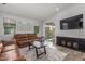 Bright and airy living room features tile flooring, comfortable seating, and sliding glass doors to the outdoor space at 4136 W Palace Station Rd, New River, AZ 85087