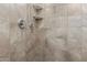 Shower close-up showcasing neutral tile, modern fixtures, and built-in shelving for convenient storage solutions at 4136 W Palace Station Rd, New River, AZ 85087