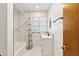 Updated bathroom features marble-style tile, modern fixtures, and a shower-tub combo at 4219 E Catalina Dr, Phoenix, AZ 85018