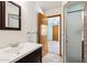 Bathroom featuring a shower stall, wall mirror, vanity and a doorway to a bedroom at 4219 E Catalina Dr, Phoenix, AZ 85018