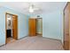 Bedroom showcasing blue walls, a ceiling fan, two doorways and wall-to-wall carpet at 4219 E Catalina Dr, Phoenix, AZ 85018