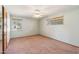 Neutral bedroom with carpet, two bright windows, and a ceiling fan at 4219 E Catalina Dr, Phoenix, AZ 85018