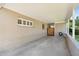 A spacious carport featuring brick walls, windows, and a wooden gate at 4219 E Catalina Dr, Phoenix, AZ 85018