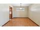 Inviting dining room with wood-look flooring, bright window, and classic chandelier at 4219 E Catalina Dr, Phoenix, AZ 85018