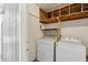 Laundry room featuring a washing machine and dryer with storage shelves above at 4219 E Catalina Dr, Phoenix, AZ 85018