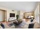 Cozy living room featuring a plush sofa, modern TV stand, and elegant decor for comfortable living at 4219 E Catalina Dr, Phoenix, AZ 85018