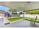 Covered patio with rocking chair overlooking a green lawn in the backyard at 4310 E Sacaton St, Phoenix, AZ 85044