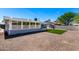 View of the backyard featuring gravel landscaping, an enclosed patio, and a small storage shed at 4310 E Sacaton St, Phoenix, AZ 85044