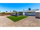 Exterior view of home showing the backyard, sunroom, patio, and mature trees at 4310 E Sacaton St, Phoenix, AZ 85044