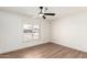 Clean bedroom with wood floors and window with shutters offering lots of natural light at 4310 E Sacaton St, Phoenix, AZ 85044