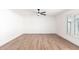 Bedroom showcasing wood-look flooring, a ceiling fan, and a window with white shutters at 4310 E Sacaton St, Phoenix, AZ 85044