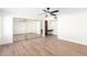 Bedroom with mirrored closet doors, wood-look flooring, and a ceiling fan at 4310 E Sacaton St, Phoenix, AZ 85044