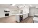 Open kitchen featuring a wine fridge, white countertops and cabinets, skylights, and wood-look floors at 4310 E Sacaton St, Phoenix, AZ 85044