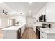 Modern kitchen with a kitchen island, stainless steel appliances, and white countertops and cabinets at 4310 E Sacaton St, Phoenix, AZ 85044