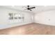 Bright, spacious living room with hardwood floors, a large window, and fresh white paint at 4310 E Sacaton St, Phoenix, AZ 85044
