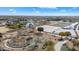 Aerial view of a park featuring multiple playgrounds, greenhouses, and ponds at 4512 S Ferric Ave, Mesa, AZ 85212