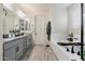Elegant bathroom with granite countertops, soaking tub and tiled floors at 4512 S Ferric Ave, Mesa, AZ 85212