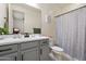 Hall bathroom with gray vanity, tile flooring and shower with tub at 4512 S Ferric Ave, Mesa, AZ 85212